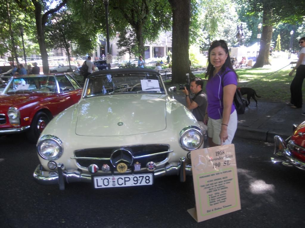 Mama posing with a car